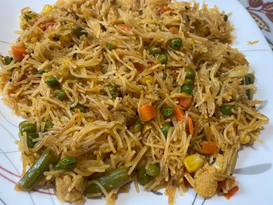 a colorful plate of noodles with vegetables